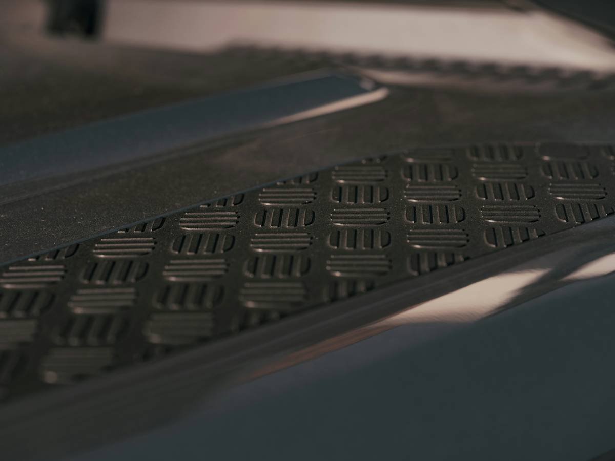 Close-up of qx4 floor mats carpet showing dense rubber composition next to worn rebond foam