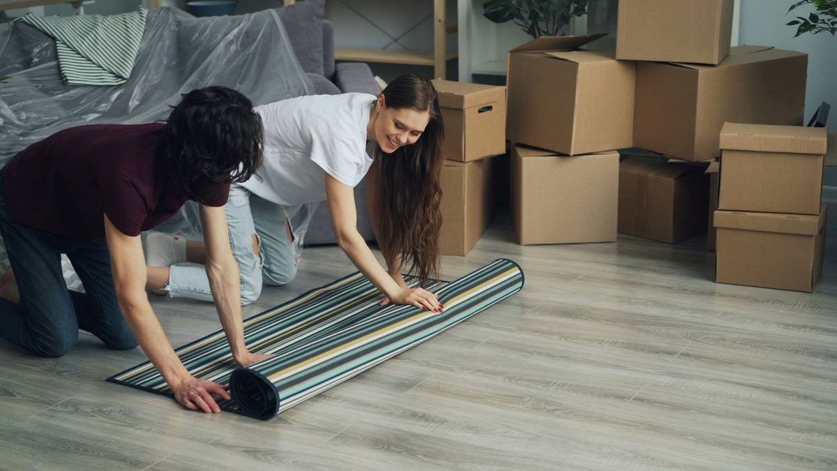 carpet and carpet padding installation showing cross-section of layered flooring with foam underlay beneath woven carpet fibers