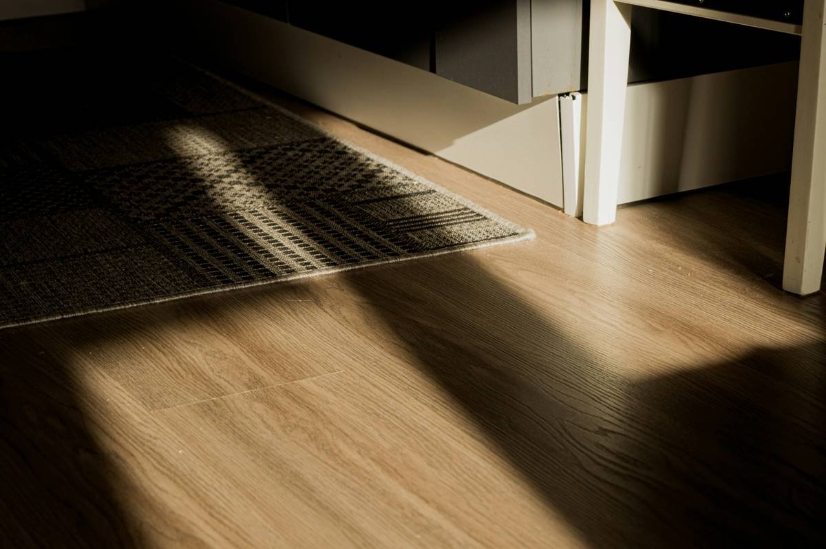Cross-section view showing moisture resistant carpet padding installed beneath carpet in a humid basement setting